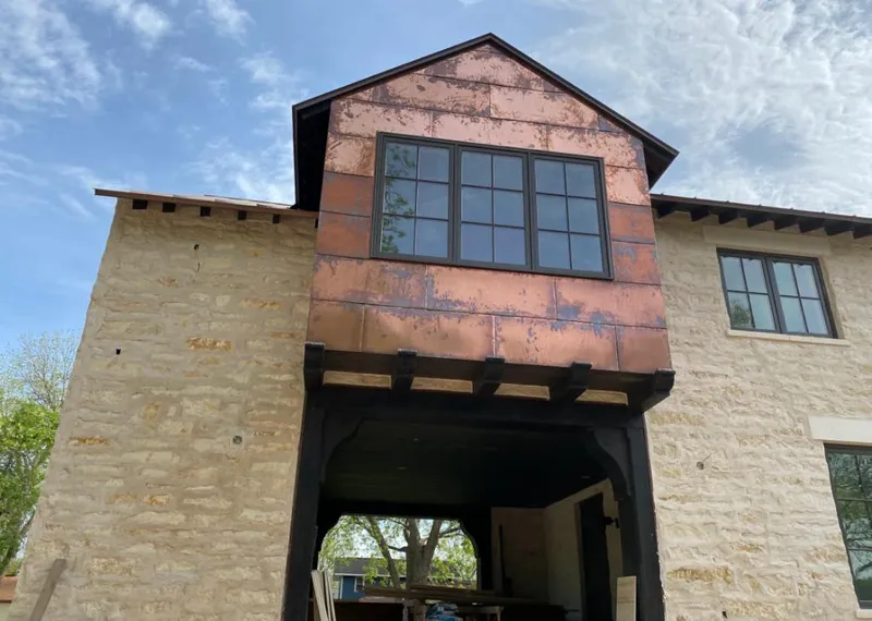 Copper metal panel facade on a stone building for Roof Repair in Lower Saucon